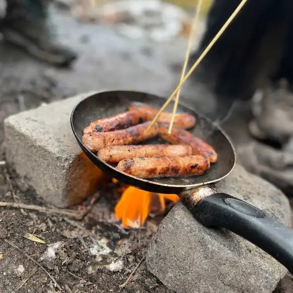 Campers gathered around a campfire at Fota Island Adventure