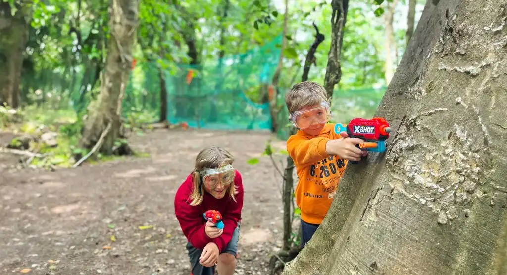 Group of teenagers climbing a rock wall at Fota Island Adventure