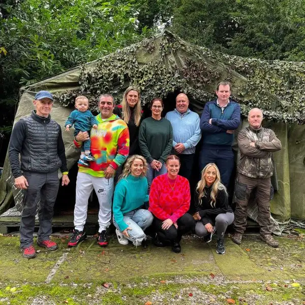 Corporate team engaged in a high ropes course challenge at Fota Island Adventure
