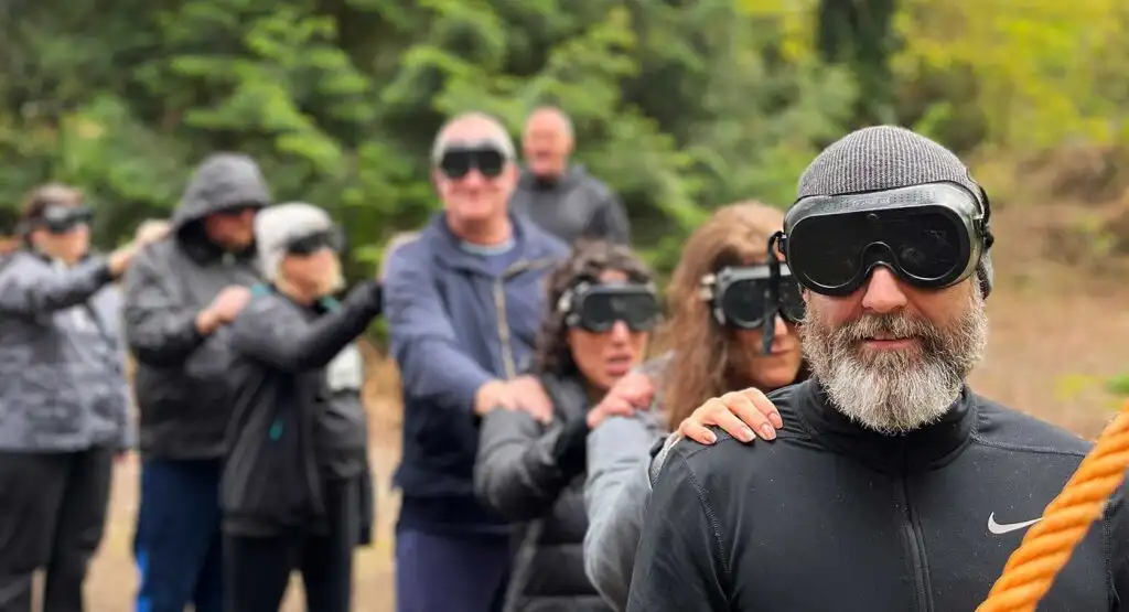 Group of colleagues participating in a team-building exercise at Fota Island Adventure, surrounded by lush greenery.