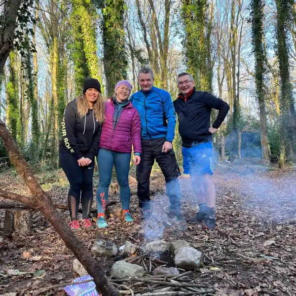 Team members celebrating after completing an obstacle course at Fota Island Adventure, highlighting achievement and camaraderie.