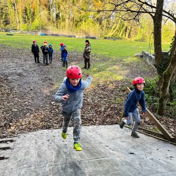 Children cheering after completing a team-building challenge at Fota Island Adventure