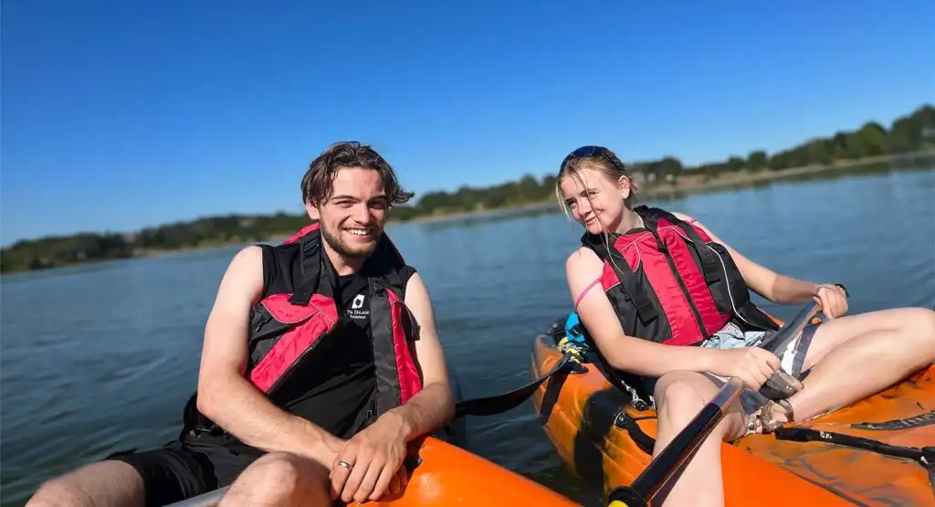 Close-up of a kayaker paddling through the water at Fota Island Adventure, with a focus on the kayak's vibrant colors.