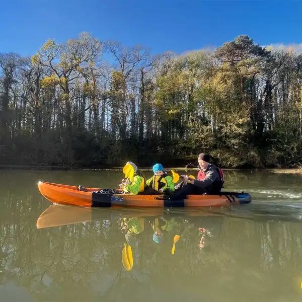 Kayakers gathered for a group photo at Fota Island Adventure, smiling and holding their paddles.
