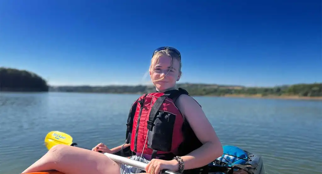 A kayaker demonstrating a paddling technique at Fota Island Adventure, with clear water visible.