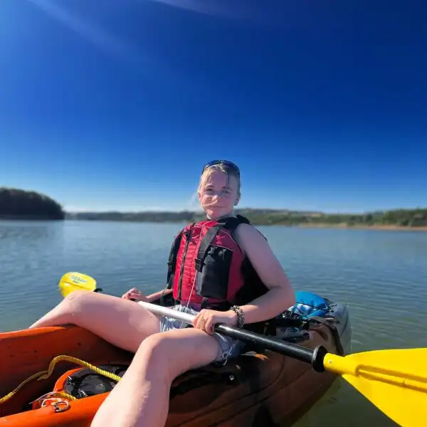 A kayaker demonstrating a paddling technique at Fota Island Adventure, with clear water visible.