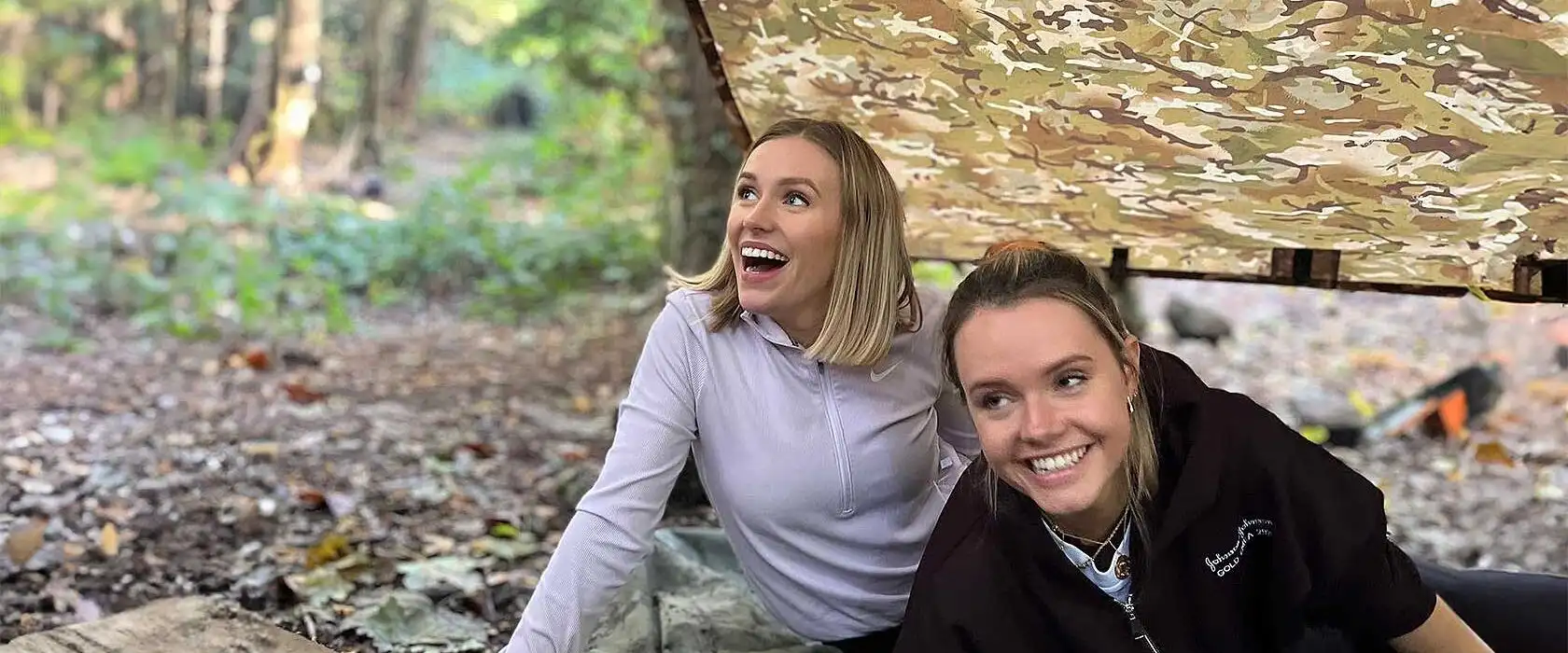 Participants at Fota Island Adventure orienteering event, checking their maps while standing near a checkpoint in a scenic outdoor setting.