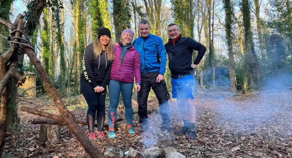 A group of people gathered around a map, planning their route for an orienteering challenge at Fota Island Adventure.