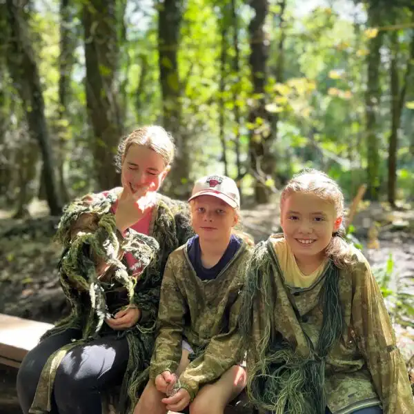 Students enjoying a zipline ride through the trees at Fota Island Adventure.