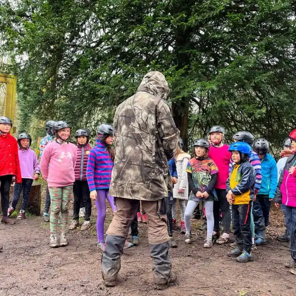 A group of children engaged in a nature walk, exploring the forest trails at Fota Island Adventure.