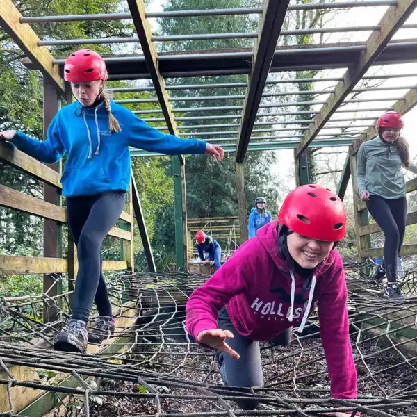 Children gathered around a campfire, roasting marshmallows at Fota Island Adventure.