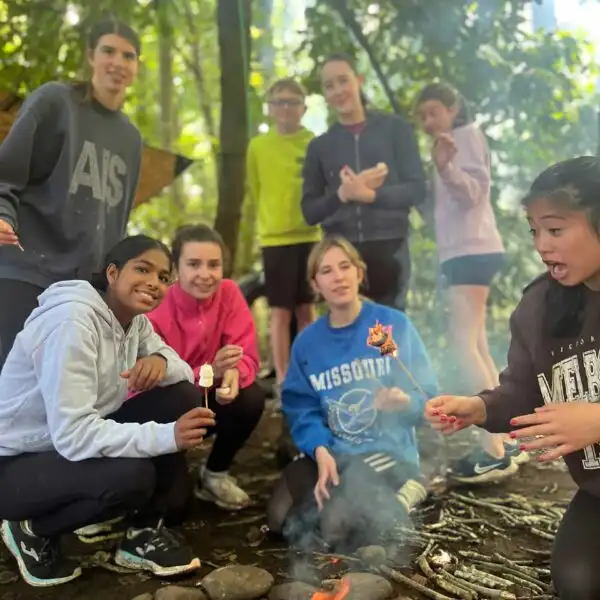 School children participating in an archery session at Fota Island Adventure, aiming at targets.