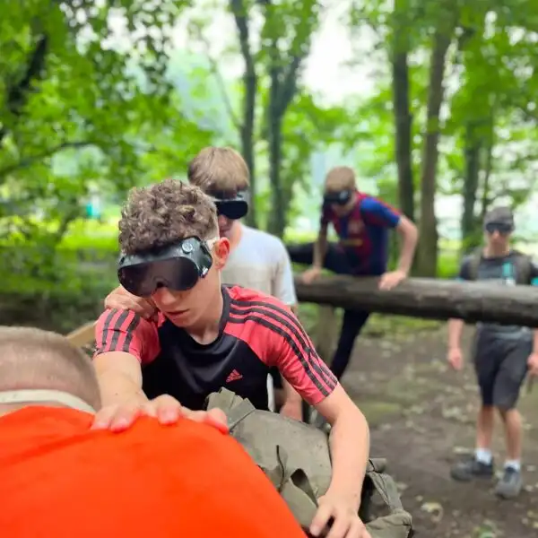 A group of coworkers at Fota Island Adventure engaged in a communication exercise, where clear instructions are key.