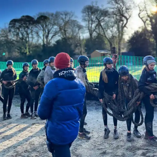Colleagues at Fota Island Adventure working together on a task that requires coordination and teamwork.