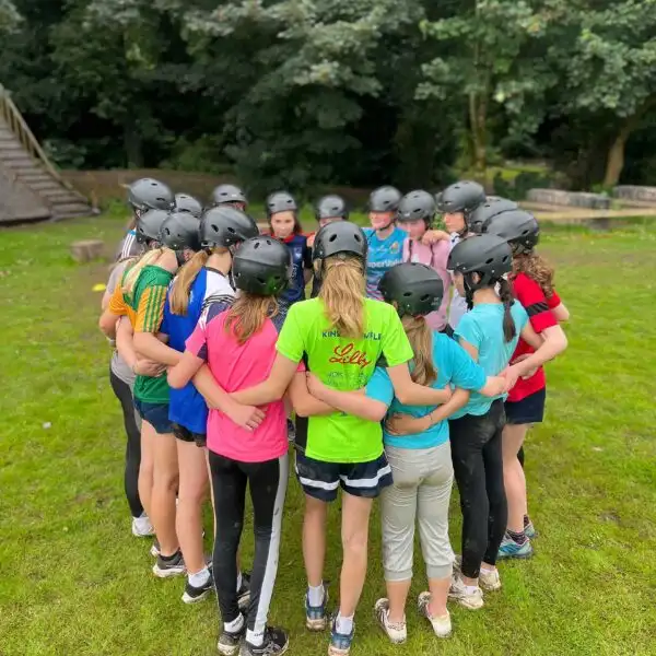 A group of coworkers at Fota Island Adventure participating in a team-building challenge that involves strategic planning.