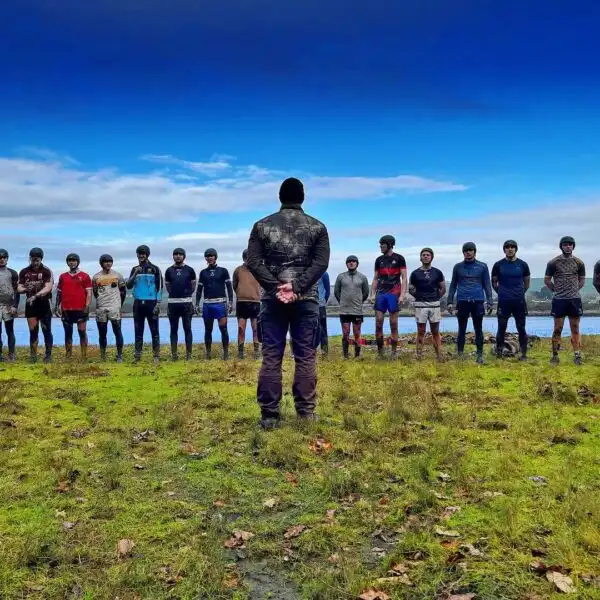 A group of colleagues participating in a team-building exercise at Fota Island Adventure, working together to solve a puzzle.